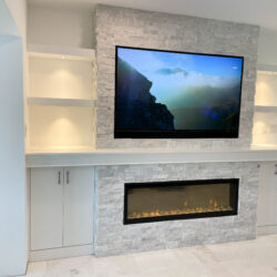 fireplace installation, natural stone, ccustom made cabinets, shelves and electric fixtures