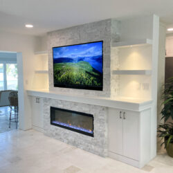 fireplace installation, natural stone, ccustom made cabinets, shelves and electric fixtures