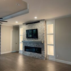 Fireplace installation, natural stone, custom made shelves and electric fixtures