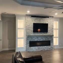 Fireplace installation, natural stone, custom made shelves and electric fixtures