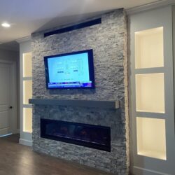 Fireplace installation, natural stone, custom made shelves and electric fixtures